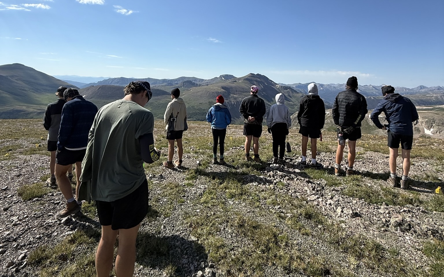 Leaders praying together on a mountain